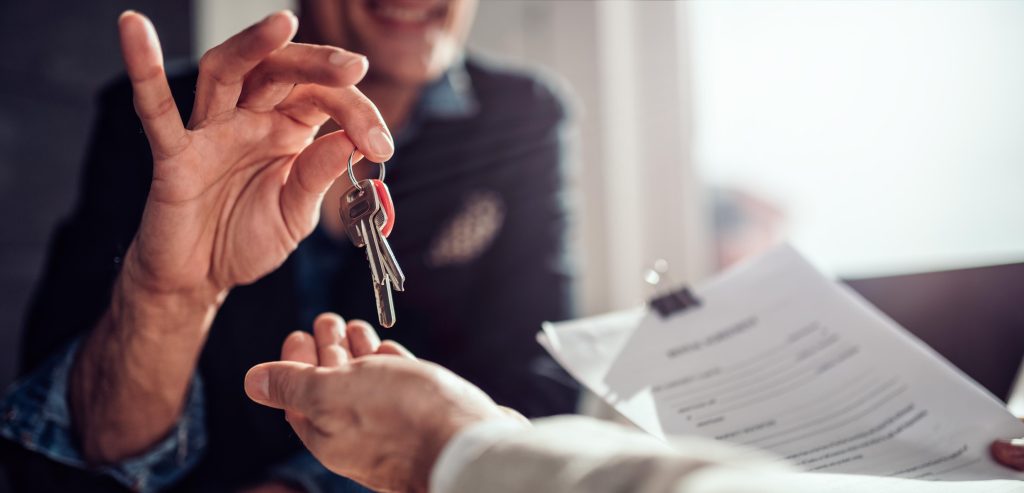 landlord handing keys to tenant